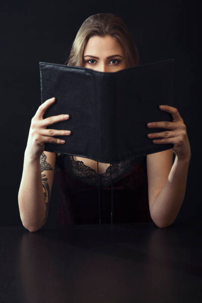 istock Young Woman Reading Book At Table 943204270