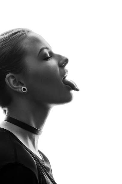 profile of beautiful young woman sticking out tongue - necklace human hair women bizarre imagens e fotografias de stock