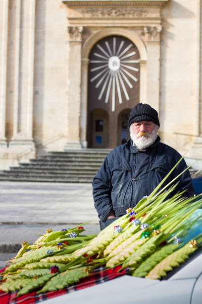 ragusa, sicily: senior vendor sells woven palm fronds - old men car vertical imagens e fotografias de stock