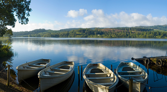 blue wooden boat is chained to the dock