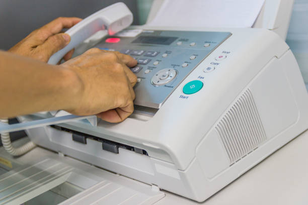 istock Men are using a fax machine in the office. Business concept 943232764