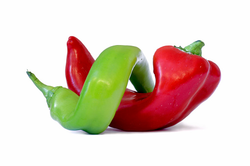 Whole and cut in half red bell pepper isolated on white background