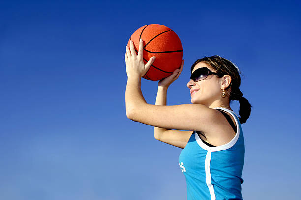 istock girl with basketball against blue sky 94324013