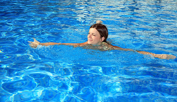 istock Happy girl swimming in a pool 94324949