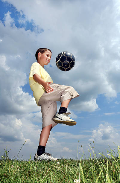 istock Boy playing soccer against the sky 94325048