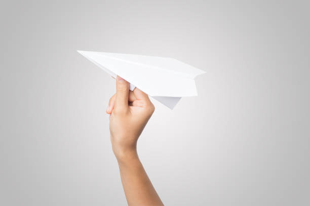 istock Woman hand Dart Paper Airplane isolated on white background. 943250708