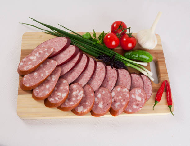 still life with sliced smoked sausage greens and tomatoes on a white background - smoked tongue imagens e fotografias de stock