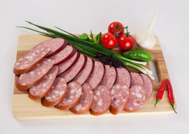 still life with sliced smoked sausage greens and tomatoes on a white background - smoked tongue imagens e fotografias de stock