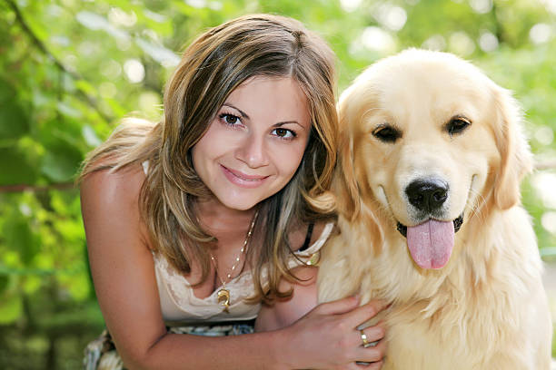 young elegant woman lie down with small dog in her arms