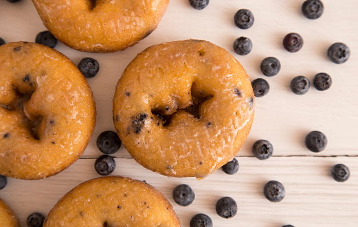 Blueberry Cake Donuts on a White Wooden Table
