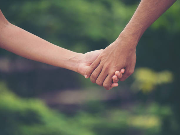 istock Image of couple holding hands together. 943265530