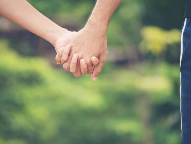 istock Image of couple holding hands together. 943265534