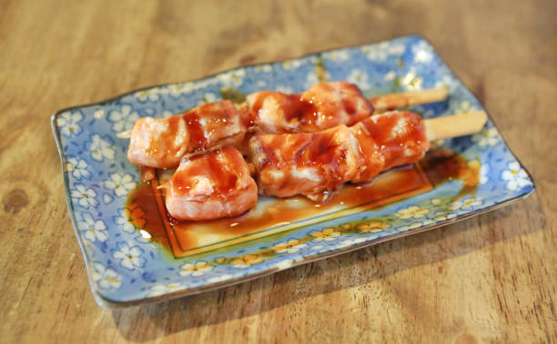 istock Grilled salmon stick on plate against wooden background. 943267756