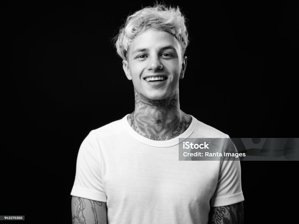 Portrait Of Tattooed Young Man Studio Portrait Of Tattooed Young Man Against Black Background Black And White Stock Photo