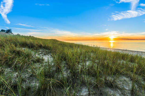 istock Sandy beach and sunset sky with golden sun shining on white sand 943279178
