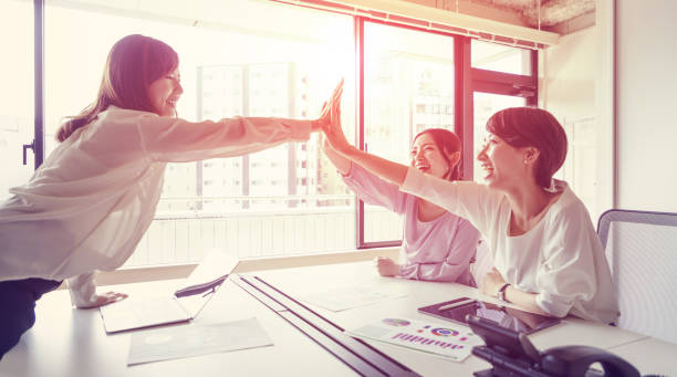istock Group of woman giving high five. 943279332