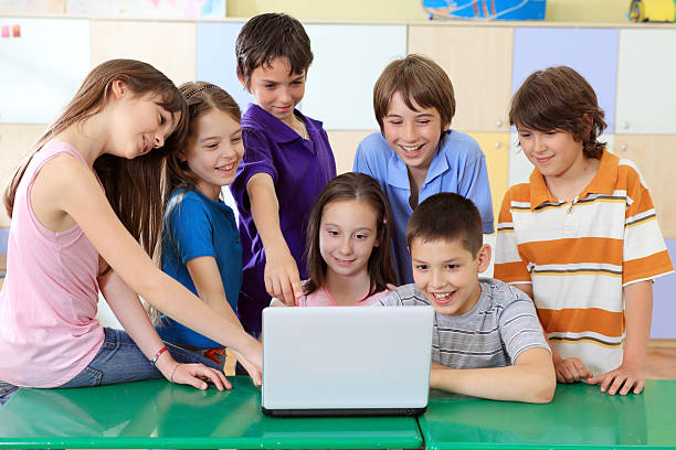 istock Children looking at laptop computer in classroom. 94328801