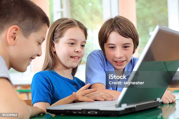 Schoolchildren Having Fun On Laptops At Classroom Stock Photo - Download Image Now - Blue, Boys, Child