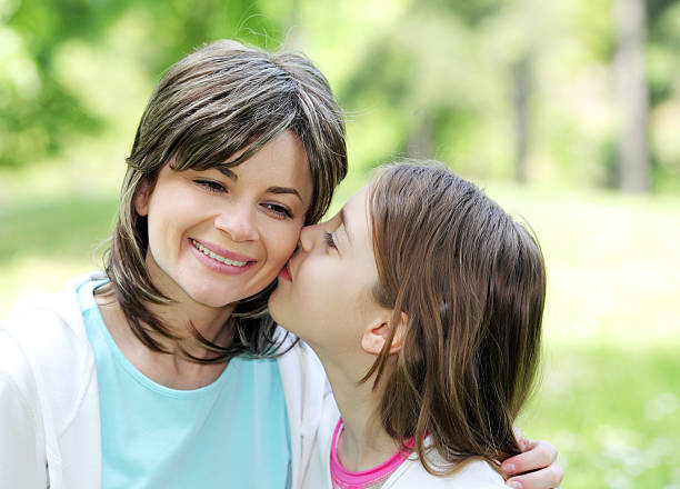 istock Cute daughter kissing her mother on cheek 94328985