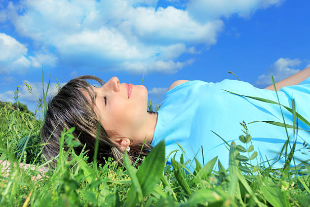 istock Young woman relaxing on meadow. 94328999