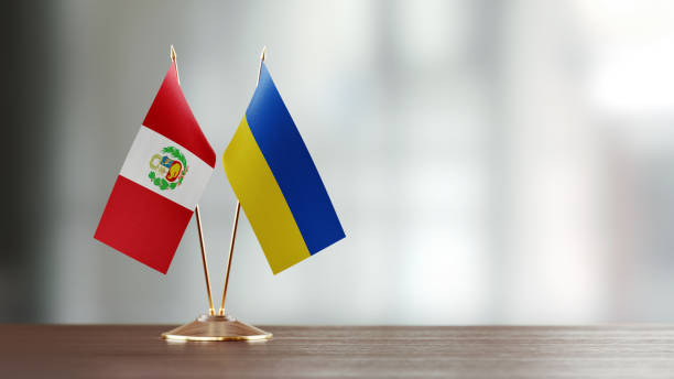 istock Peruvian And Ukrainian Flag Pair On A Desk Over Defocused Background 943290078