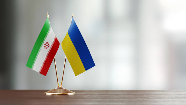 istock Iranian And Ukrainian Flag Pair On A Desk Over Defocused Background 943290124