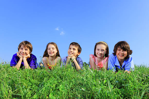 istock Group of five cute children resting on grass. 94329204