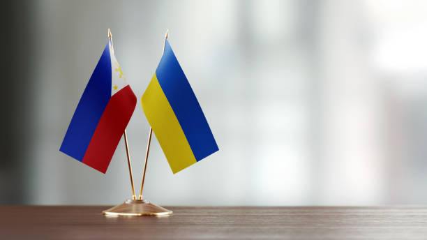 istock Philippines And Ukrainian Flag Pair On A Desk Over Defocused Background 943293260