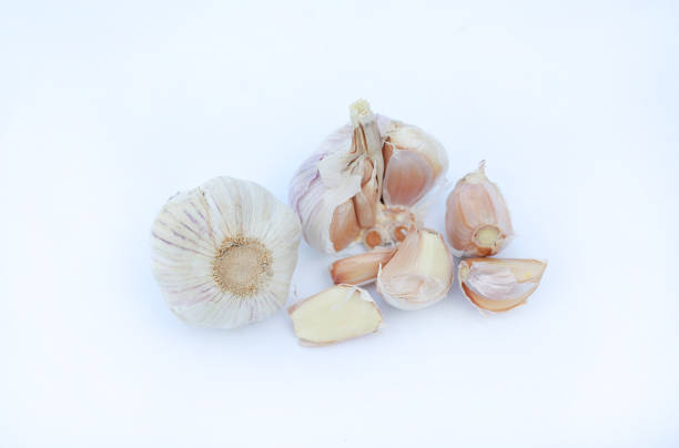 istock garlic cloves on white background. 943293358