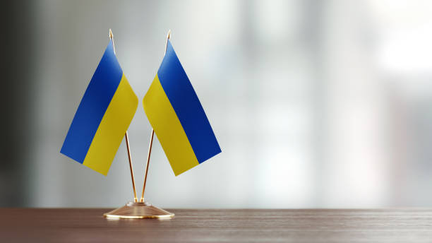 istock Ukrainian Flag Pair On A Desk Over Defocused Background 943293432