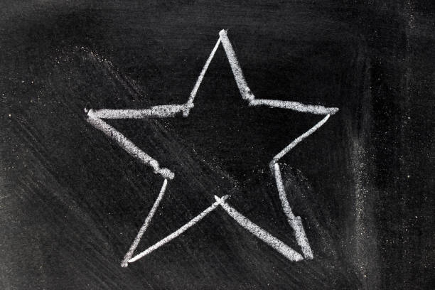 istock White chalk hand drawing in star shape on blackboard background 943293680