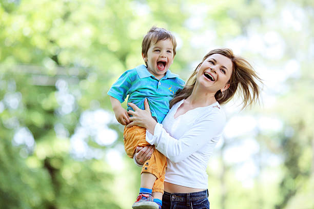 istock Happy mother with her cute little son having fun outside. 94329393