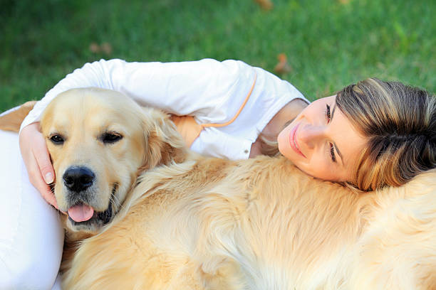 istock Girl with her dog lying down on grass. 94329398