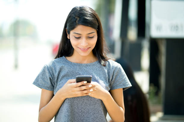 istock Beautiful woman using mobile phone 943295838