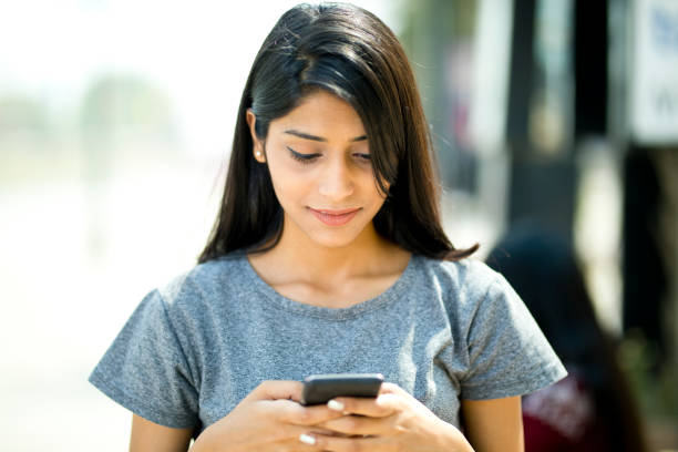 istock Beautiful woman using mobile phone 943295870
