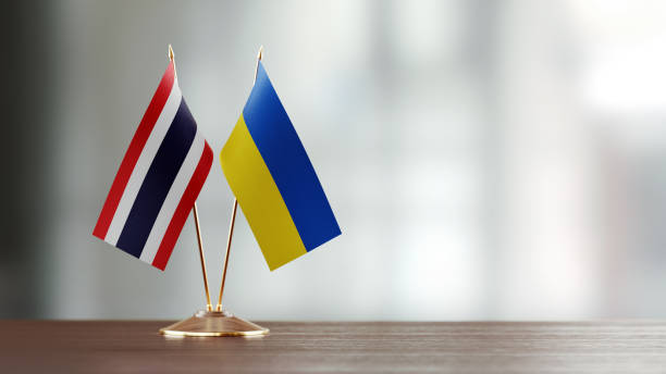 istock Thai And Ukrainian Flag Pair On A Desk Over Defocused Background 943296320