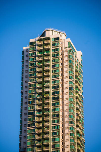 istock High rise condominium building against blue sky background 943297032