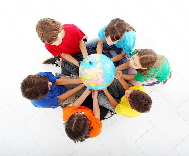 istock Kids holding together a terrestrial globe. 94329918