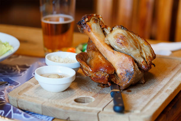 istock Pork knuckle on a Board with sauces and beer 943299972