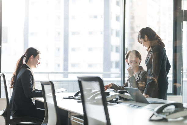 istock Three businesswomen working in the office. Positive workplace concept. 943301344