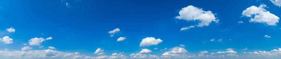 Panoramic skyscape from the horizon of clouds in a blue sky in summer.