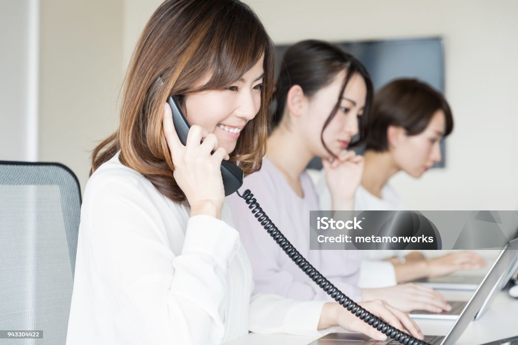 Young woman making a call. Using Phone Stock Photo