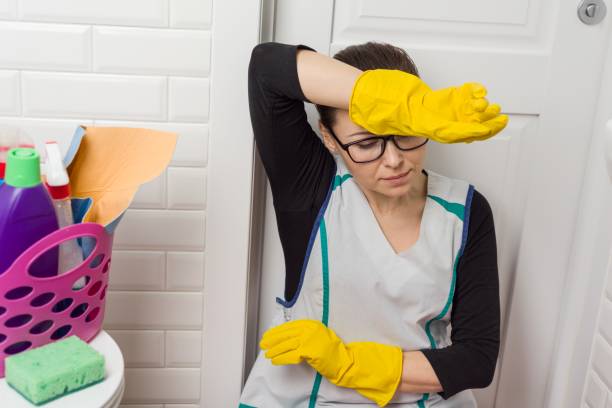 istock Tired housewife wipes her forehead with her hand 943305284