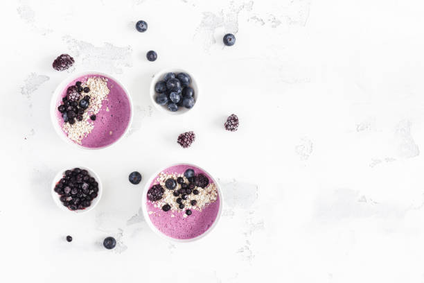 istock Breakfast with muesli, blueberry smoothie, fruits. Flat lay, top view 943307836