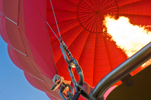 Hot air balloon with bright burning flame in the night