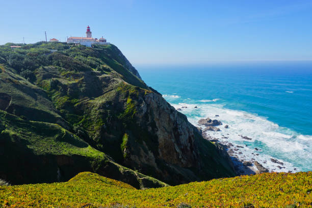 The lighthouse on the top of the cliff at Cabo da Roca (Cape Roca) the westernmost point of Europe near Sintra Portugal. stock photo