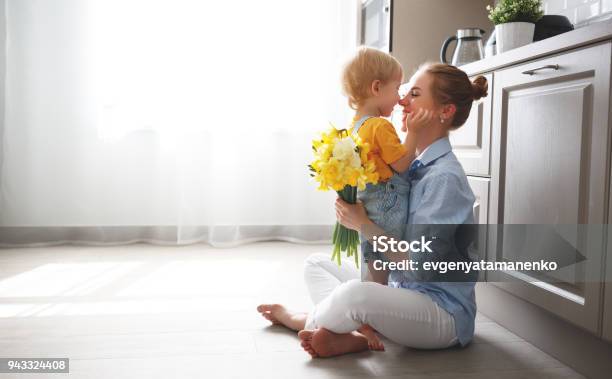 Happy Mothers Day Baby Son Gives Flowersfor Mother On Holiday Stock Photo - Download Image Now