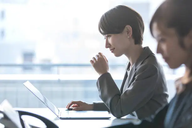 Photo of Businesswomen working in the office. Positive workplace concept.