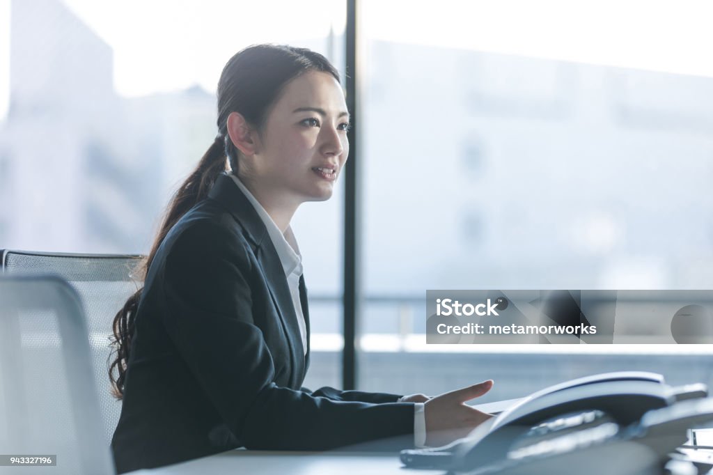 Businesswoman working in the office. Positive workplace concept. Japanese Ethnicity Stock Photo
