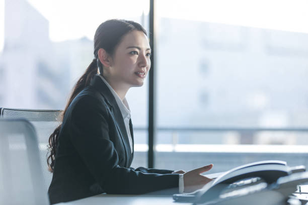 Businesswoman working in the office. Positive workplace concept. Businesswoman working in the office. Positive workplace concept. japanese ethnicity stock pictures, royalty-free photos & images
